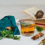 Herbal tea, cinnamon, and fresh herbs on a table — natural allergy remedies for seasonal relief.