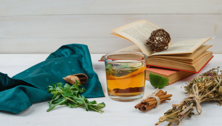 Herbal tea, cinnamon, and fresh herbs on a table — natural allergy remedies for seasonal relief.