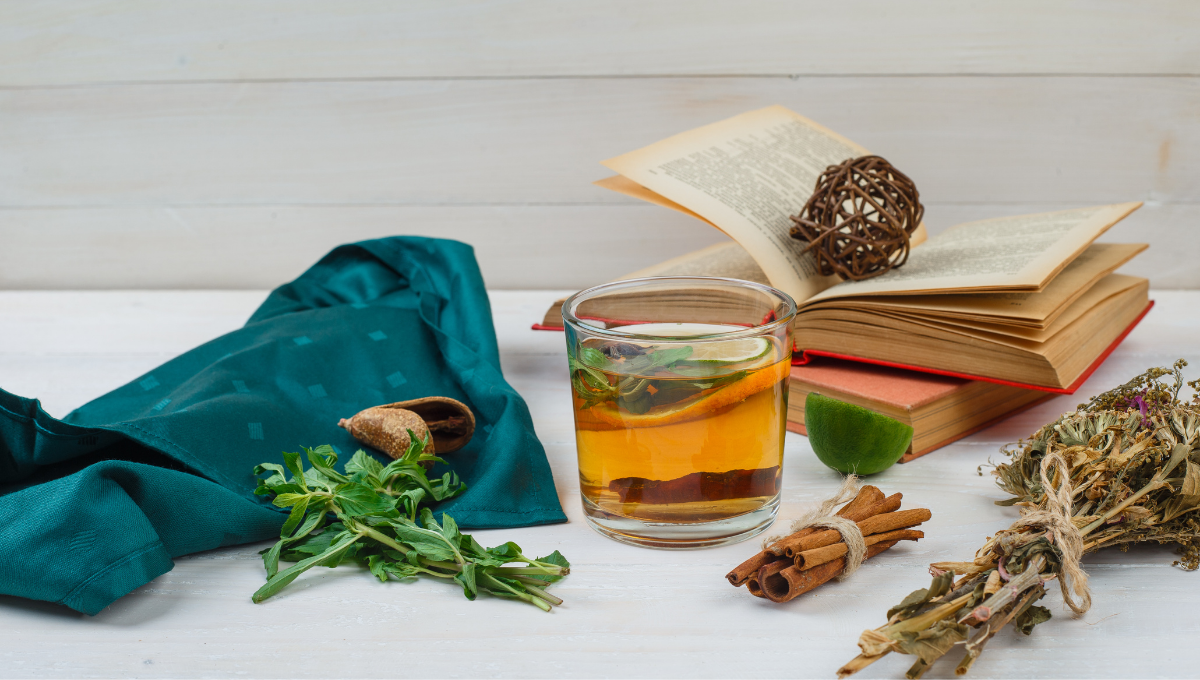 Herbal tea, cinnamon, and fresh herbs on a table — natural allergy remedies for seasonal relief.