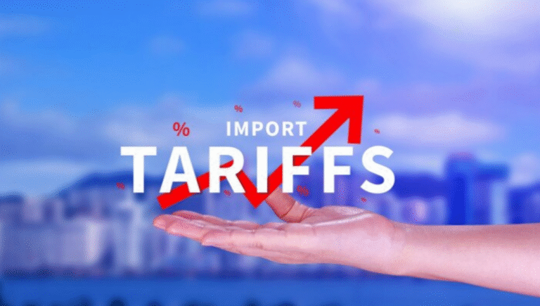 Graphic showing the rising Tariff Impact, with an upward red arrow and the text 'IMPORT TARIFFS' held by a hand.