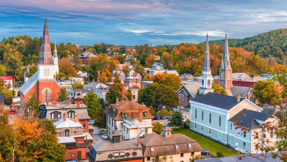 Colorful autumn view of a church and historic buildings in a small scenic city, showcasing the charm of Historic Towns of America.