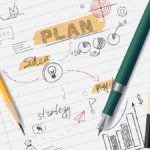 A notebook page showing the process of creating a student education plan with hand-drawn charts, a target, and the words "strategy" and "idea."